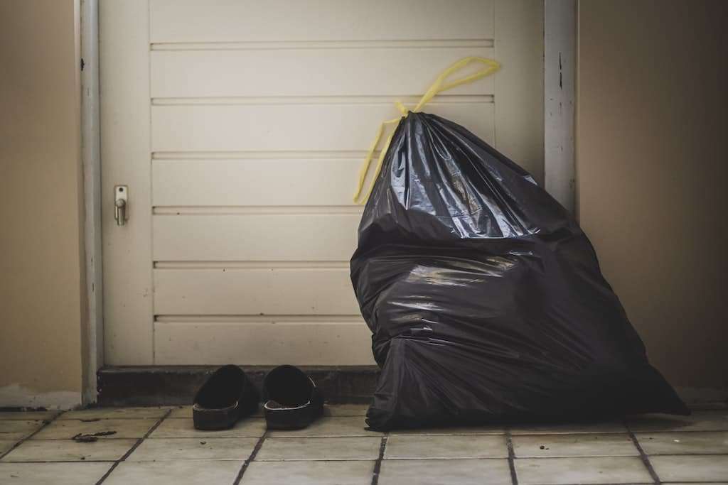 A trash bag waits to go to the curb