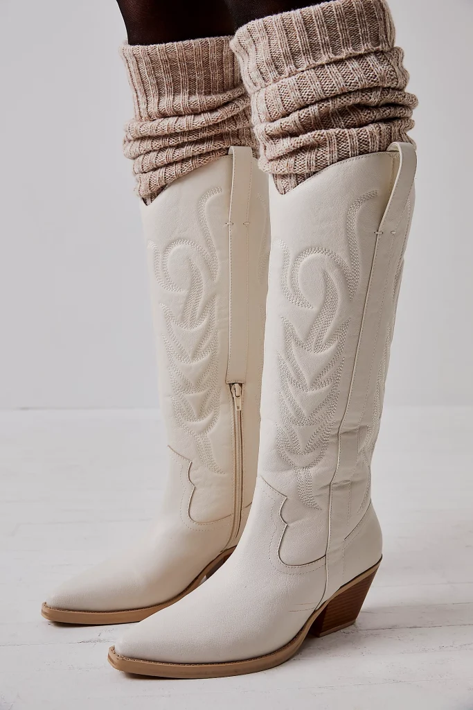 Free People white knee-high cowboy boots.