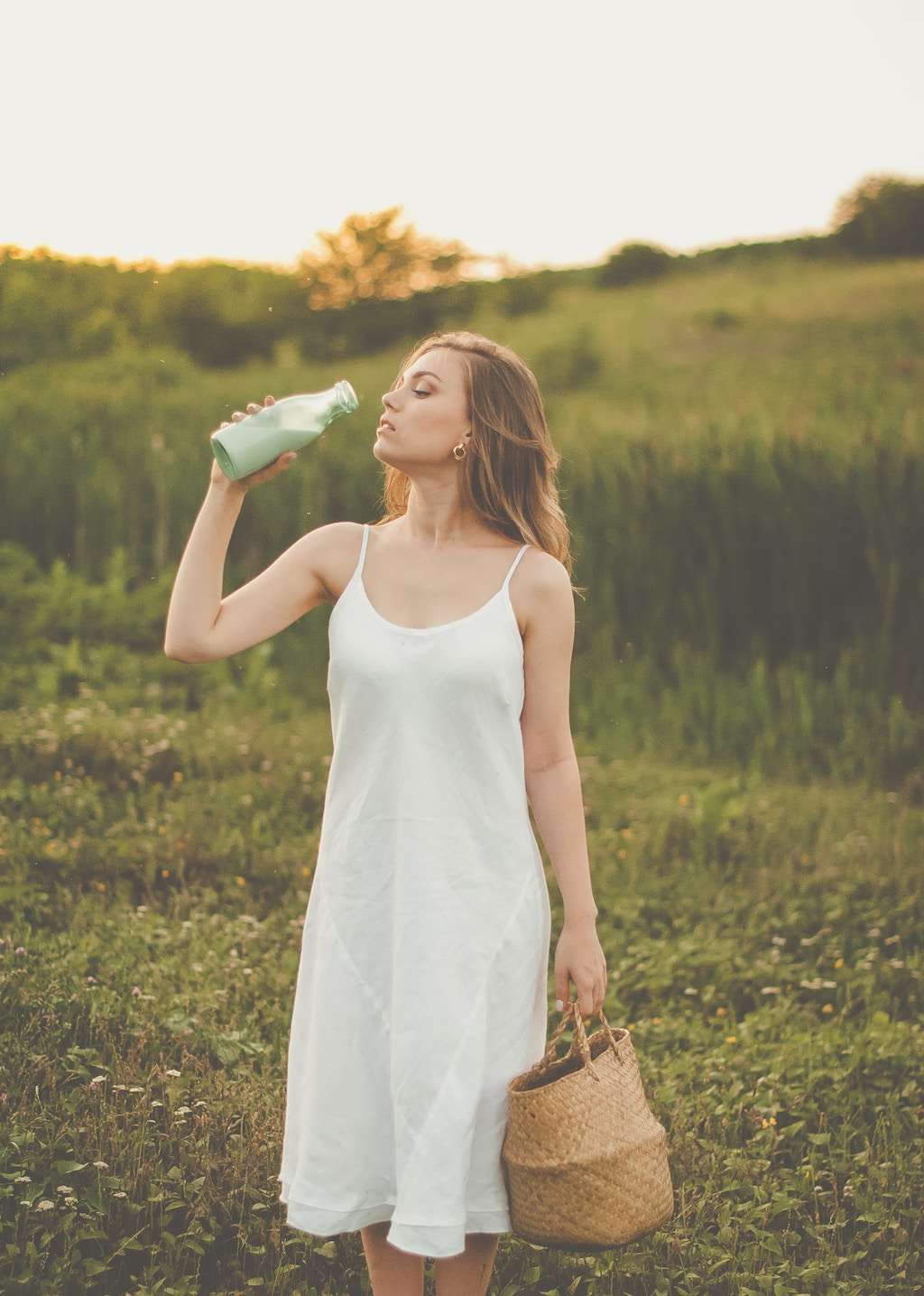 woman with tote bag and reusable bottle