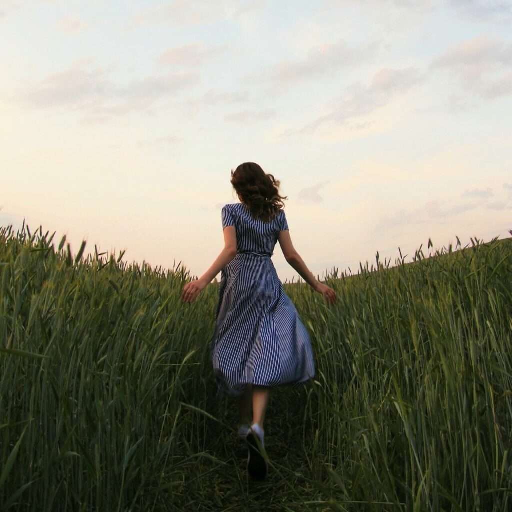 woman running through field