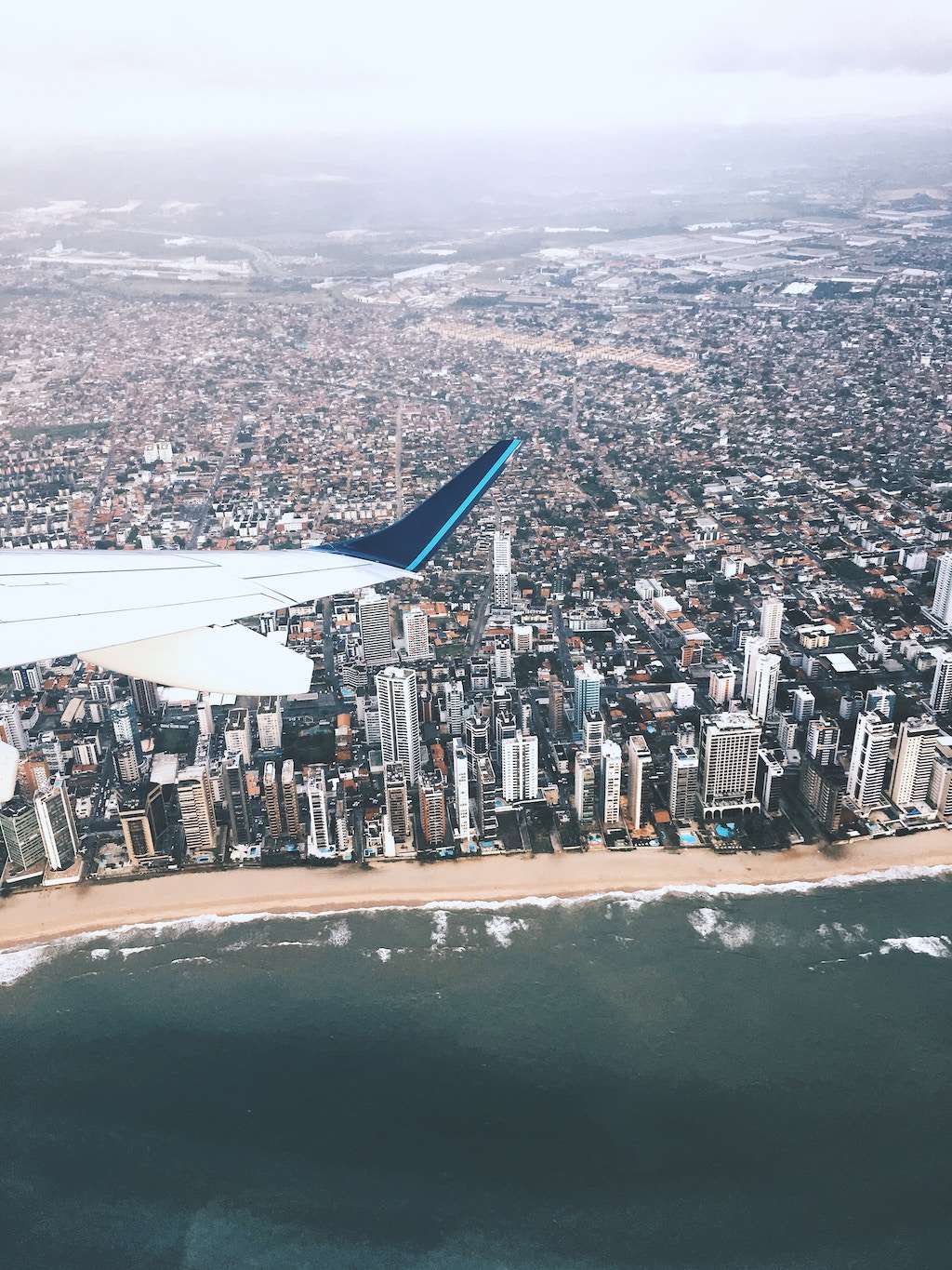 An airplane flies over Recife, Brazil.