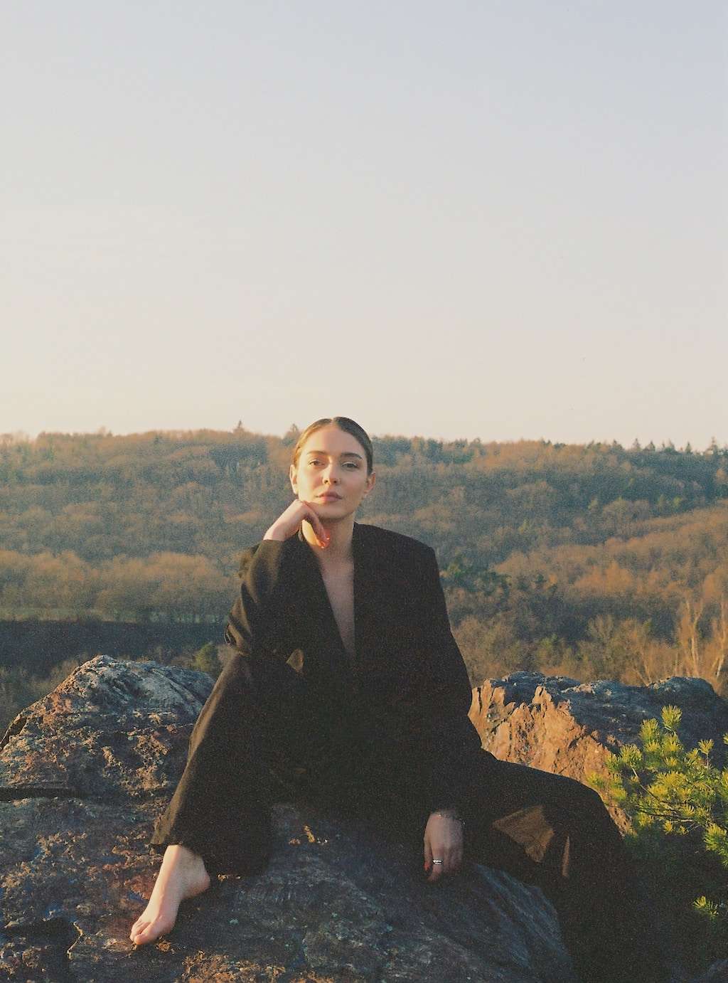 woman in a suit on a rock