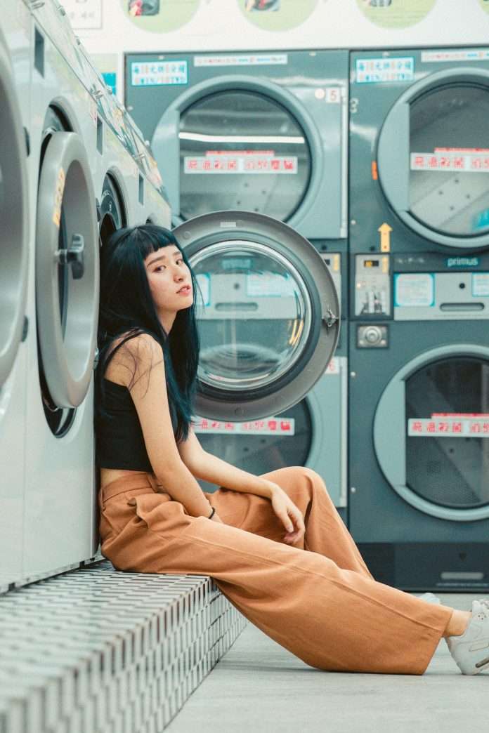 woman sitting in laundromat