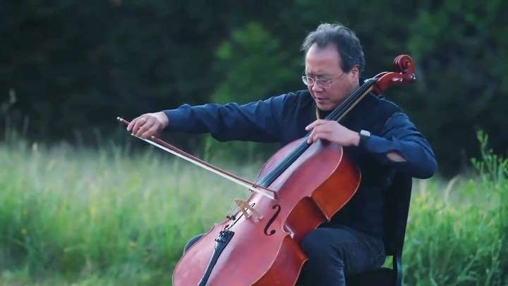 Cellist Yo-Yo Ma in a field