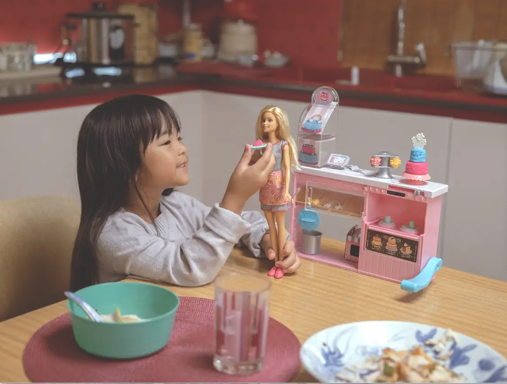 A child plays with Barbie in a Mattel ad