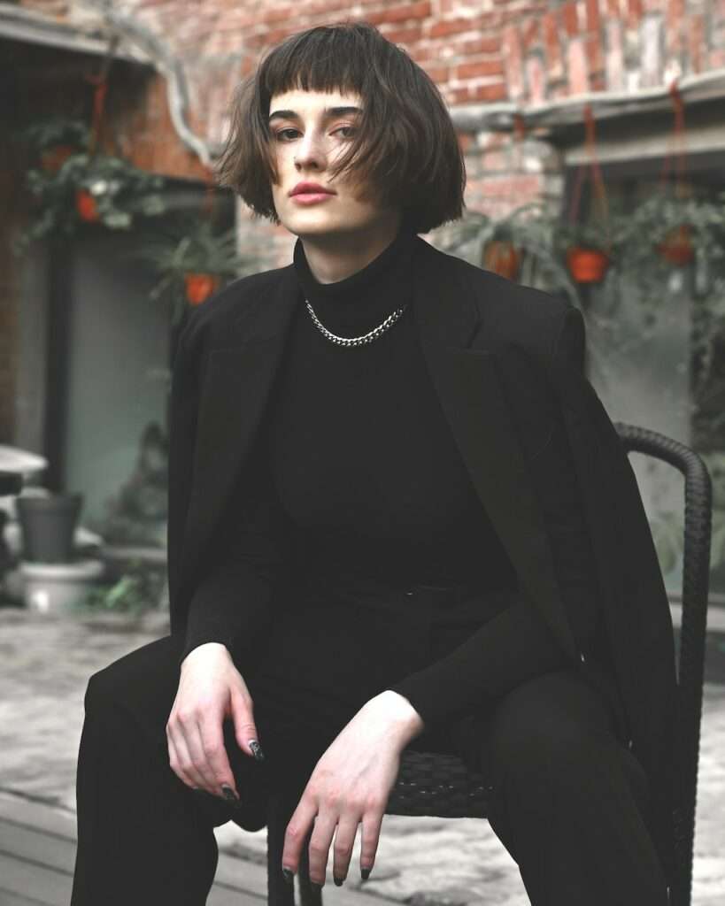 Woman in black suit.