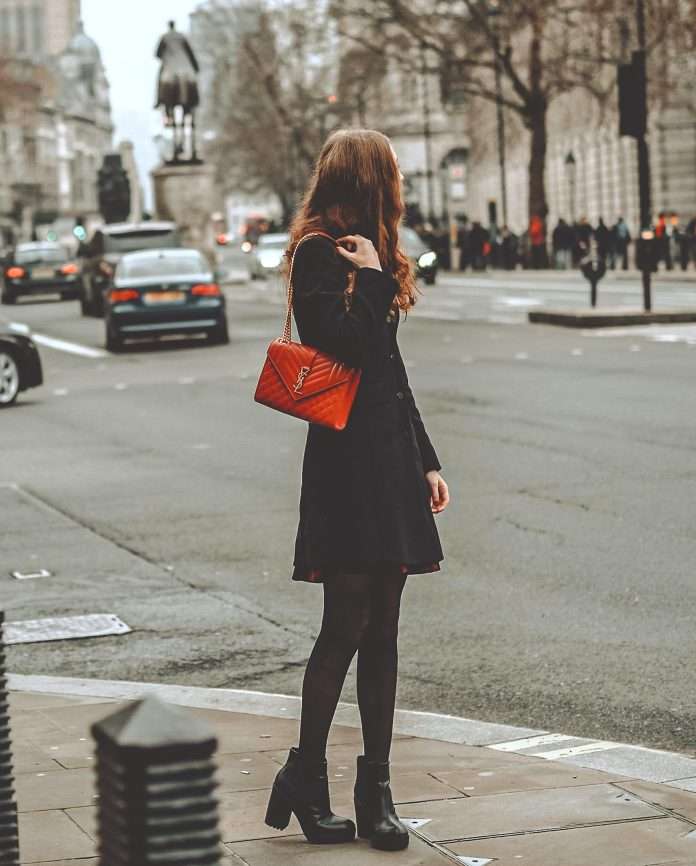 woman on street with red bag