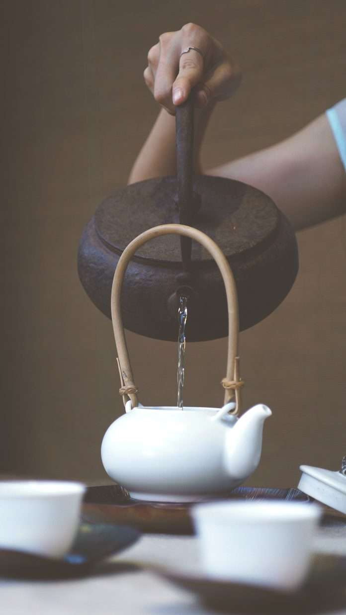 pouring water into tea