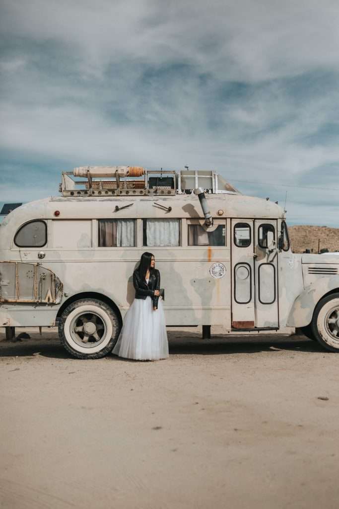 woman in front of a bus at burning man