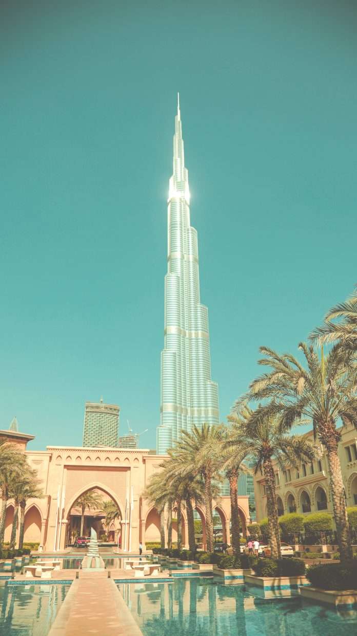 The entrance to the Palace Hotel in Dubai with Burj Khalifa in the background.