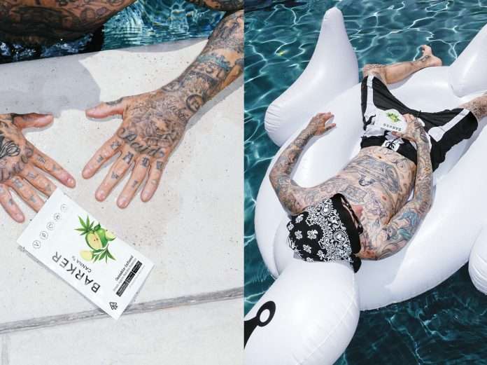 Travis Barker on a pool floatie with gummies