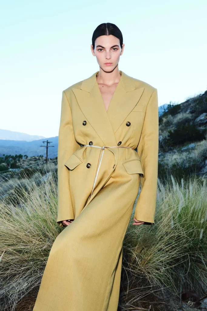 Woman in H&M trench coat.
