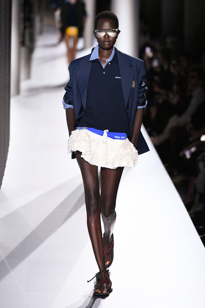 Model wears Miu Miu RTW SS24 outfit on the runway.