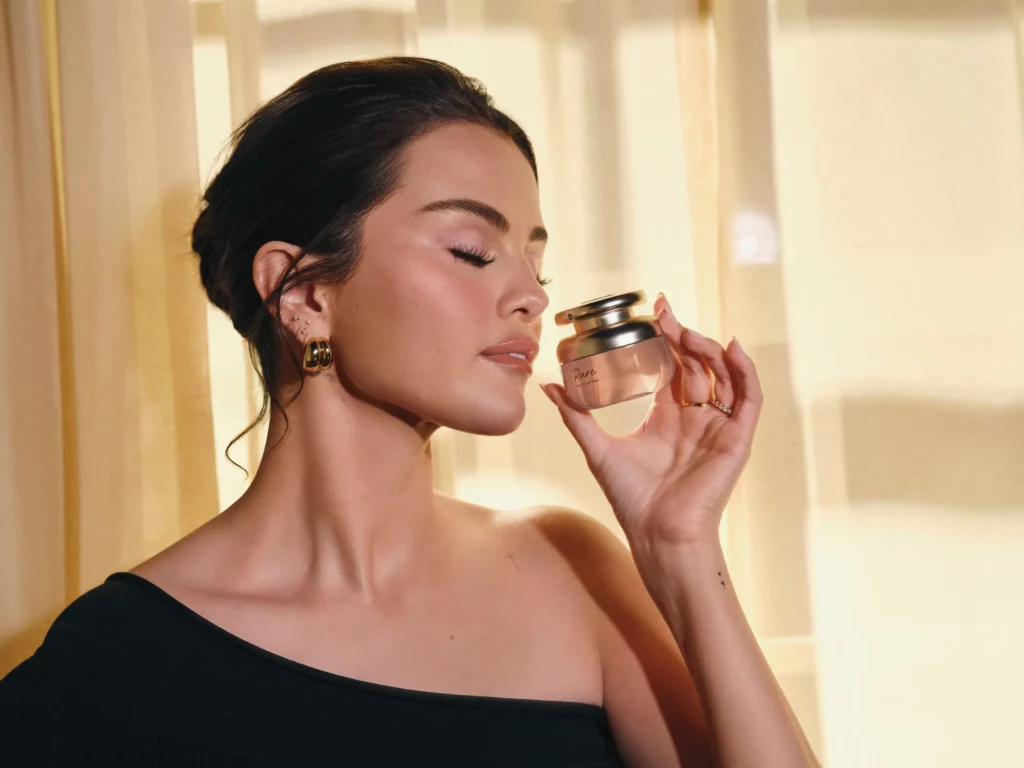 Selena Gomez smells her Rare Beauty fragrance.