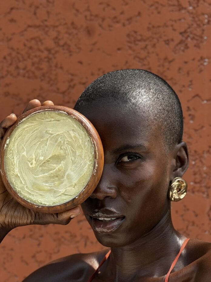 Woman with Amila shea butter.